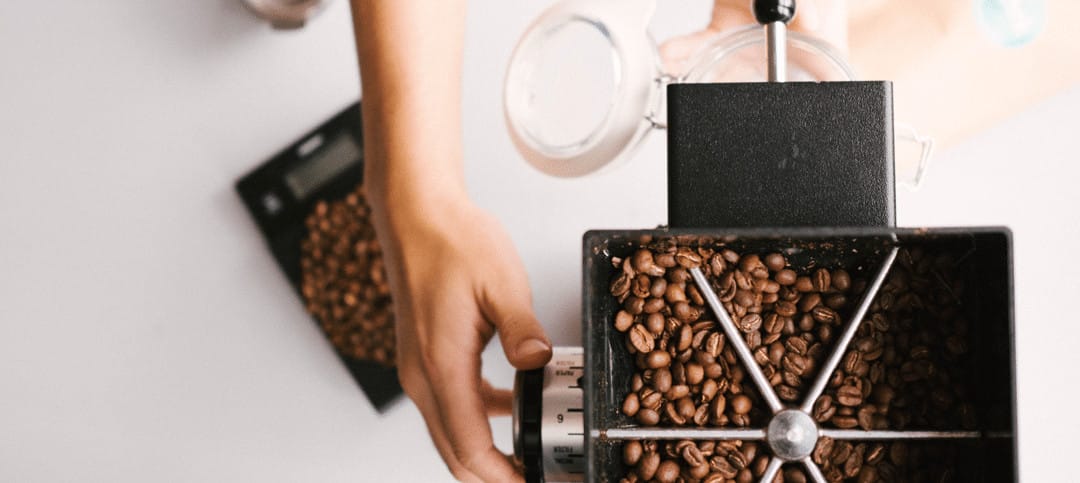Grinding fresh coffee beans to ensure freshness